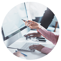 User pointing at desktop computer with pen