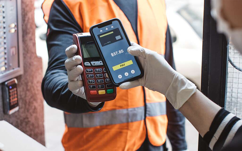 Man in high vis jacket using point of sale