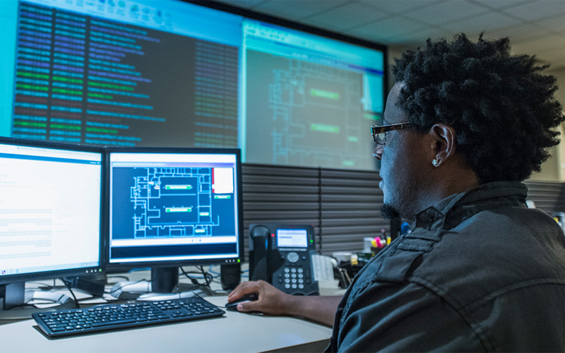 Man looking at monitors