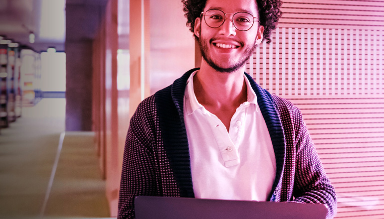 man smiling while sat at a desk