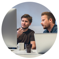 Two colleagues working together on computers