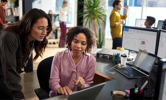 Two colleagues working on Microsoft software