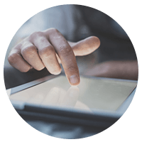 Close up of hand on touch screen of tablet
