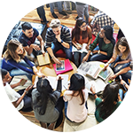 Group of students sitting on floor with mobile devices