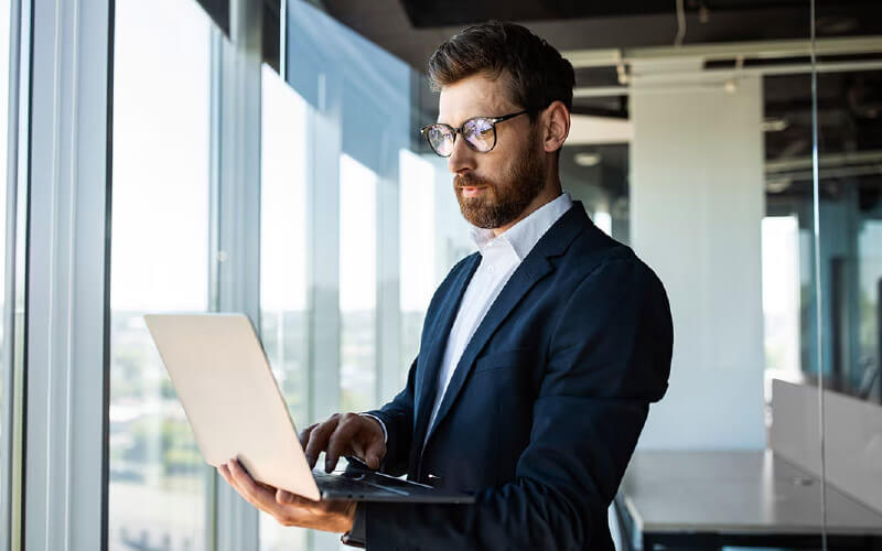 Faster connectivity Man with glasses using his laptop