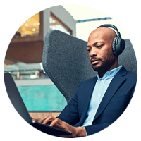 Professional working on laptop using ADAPT headset