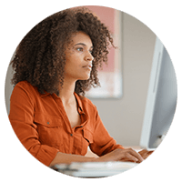 Woman using desktop computer to gain visibility into entitlements 