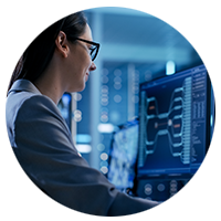 Woman working on a computer in a server room.