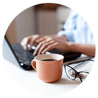 Hands typing on laptop