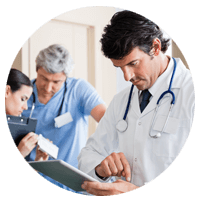 Doctor managing patients and staff on tablet device