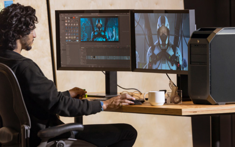 Man video editing in office