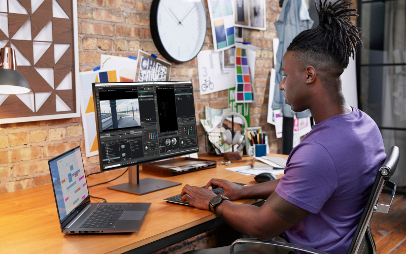 Man video editing in office