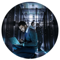 IT technician reviews server data in data center