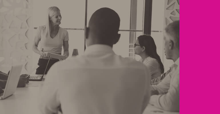 Business leader presents to team in conference room