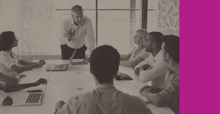 Team discusses server workloads in conference room
