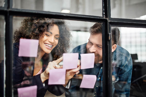 Colleagues brainstorming with sticky notes