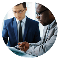 Two businessmen go over different hiring options on tablet device
