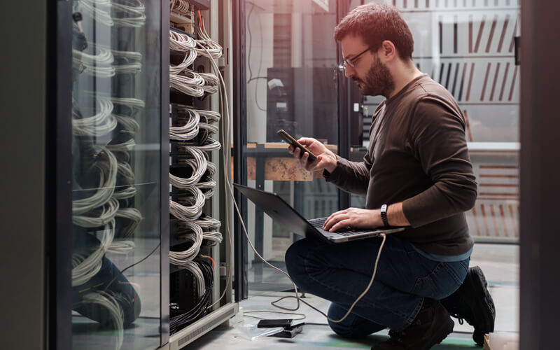 IT technician testing server in data center
