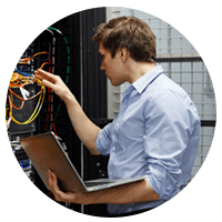 IT engineer on laptop computer in data center