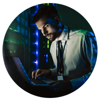 Professional engineer monitors security on laptop in data center