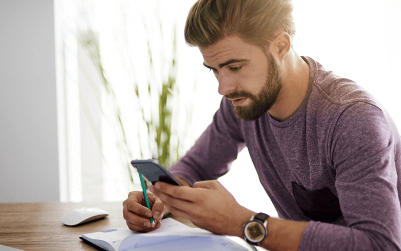 Man using cloud technology on mobile phone