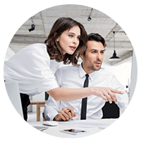 Two business men at desk discuss mergers and acquisitions