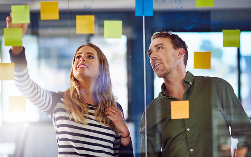 Brainstorming session with sticky notes in open office