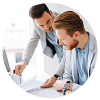 Two business men review reports on desk