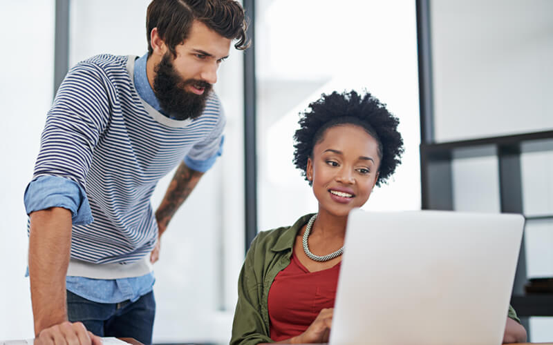 Two business professionals explore the new software solutions on laptop