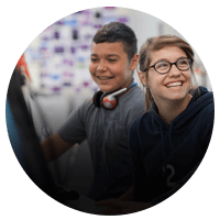 Two young students using Adobe applications.