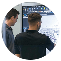 Two employees collaborating on touchscreen using Bluebeam technology