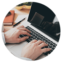 Hand typing on laptop