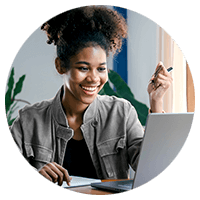 Curly hair woman smiling using a laptop