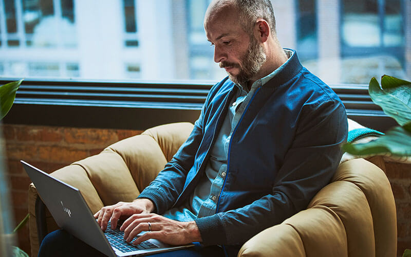 Simplified Management Man working using hp laptop