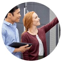 Man with tablet looks to where woman is pointing
