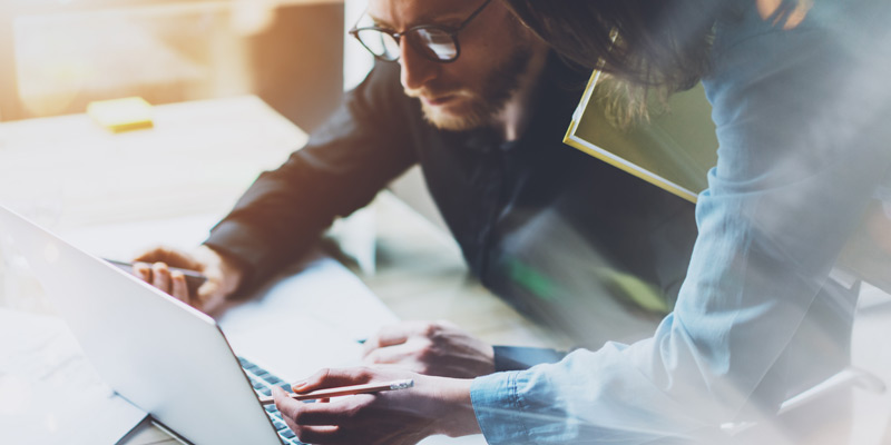 Business man in glasses working on laptop