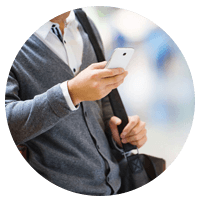 Man in sweater outside holding phone