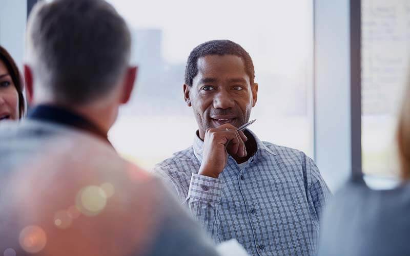 We evaluate your needs to craft a custom solution that meets your goals. Business team listen and collaborate in team meeting