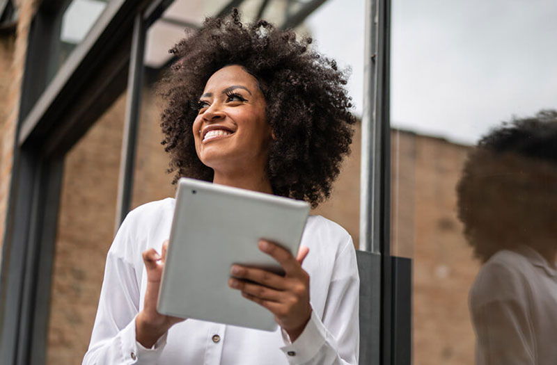 Woman outside holding tablet