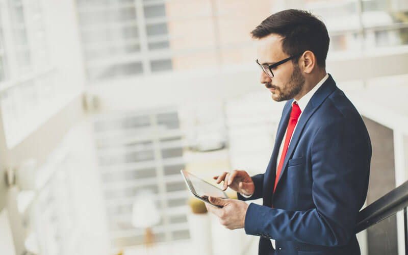 Business man using tablet device in office space