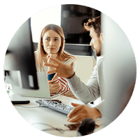 Woman looking at monitor displaying spreadsheet.