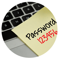 Sticky note with password written on it stuck to keyboard.