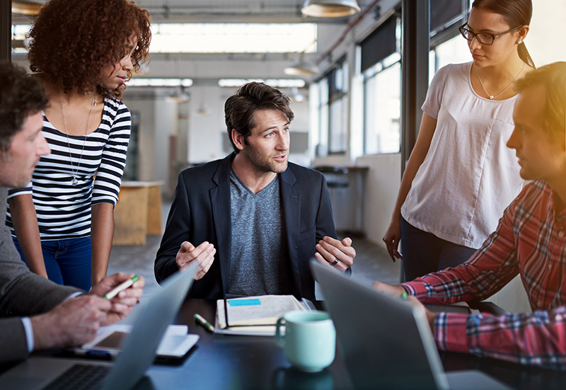 We’ll help you maintain compliance Group of business professionals in meeting about cloud strategy
