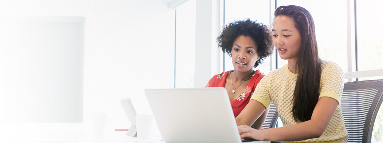 Business woman discuss information found on laptop