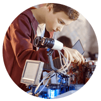 Student in engineering class work with robotics