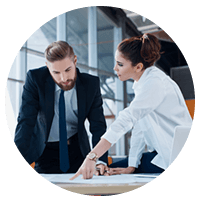 Two standing business professionals working on strategic decisions at desk