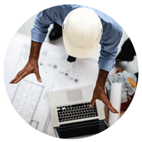 Top down view of architect onsite with laptop device
