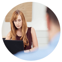 Mature business woman works on laptop computer