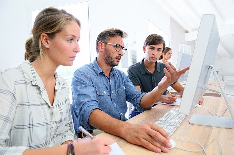 Collaborate more effectively and creatively Teacher reviewing a students work on desktop computer