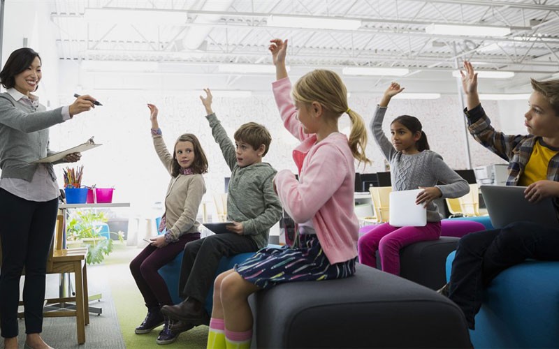 Microsoft Azure is a powerful tool for research and education Classroom of children and teacher learning while using laptop and tablet devices